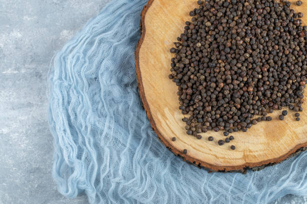 istock A wooden board with dried peppercorn on a gray background 1304378639