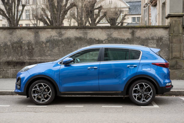 Rear view of blue Kia sportage SUV car parked in the street stock photo