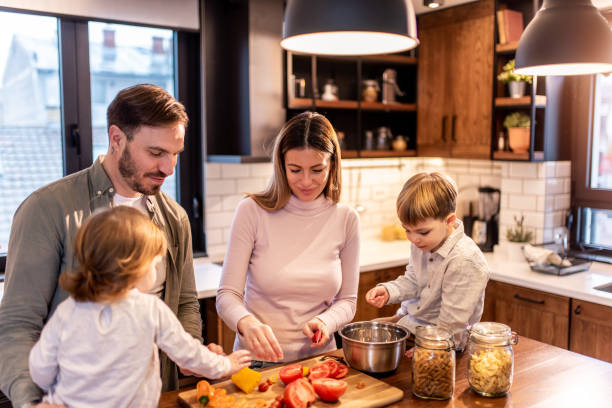 istock Happy family preparing lunch in the kitchen. 1304381790