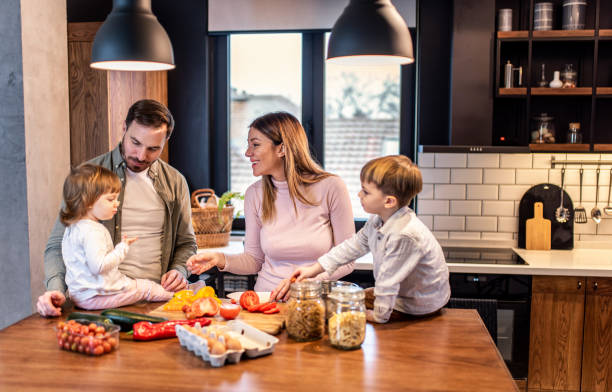istock Happy family preparing lunch in the kitchen. 1304381988