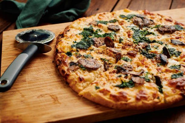 istock Close up of a sliced Spinach and Mushroom pizza. 1304384822
