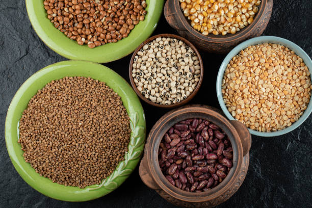 istock Different kinds of beans in colorful bowls 1304385959