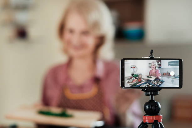istock Senior Blogger Live Cooking at Kitchen 1304386256