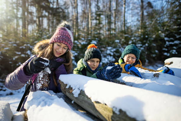 istock Children enjoying hiking in winter forest. 1304390540