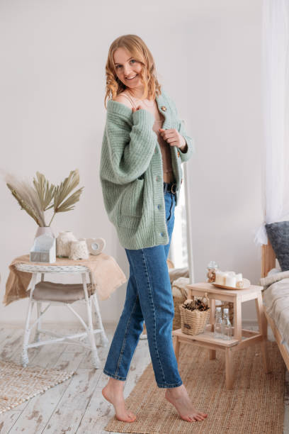 image of happy young woman posing isolated over home background. beautiful female looks at camera having her blonde hair. face expression, feelings and attitude - iguana reptile smiling human face imagens e fotografias de stock