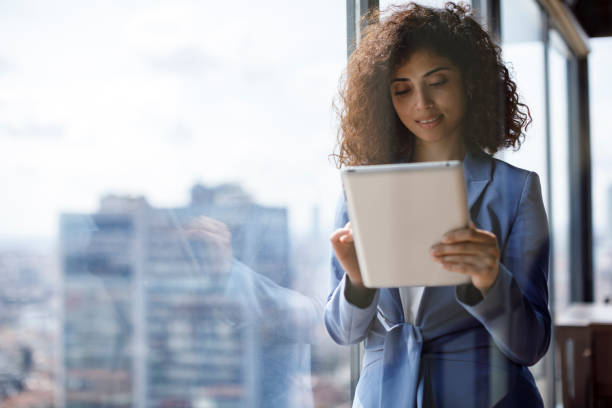 istock Young smiling businesswoman using using digital tablet in office 1304392204