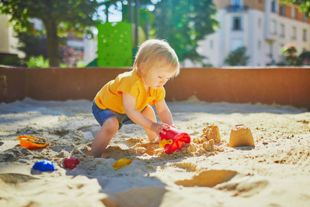 istock Adorable little girl having fun on playground in sandpit 1304393986