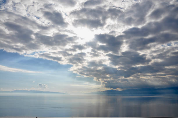 istock Cloudscape with sunrays over sea in Rijeka, Croatia. Sea on cloudy sky. Clouds on dramatic sky. Evening nature and sunset. Freedom and wanderlust concept. 1304396923