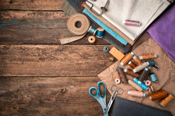 istock A set of fabrics, threads and other sewing accessories on a wooden background 1304397121