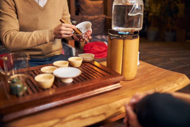 istock Young man performing traditional tea ceremony in cafe 1304398498