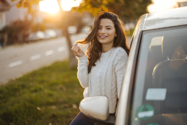 istock Woman standing by her car 1304401296