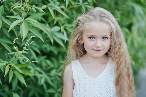 Joyful little girl on a white background.