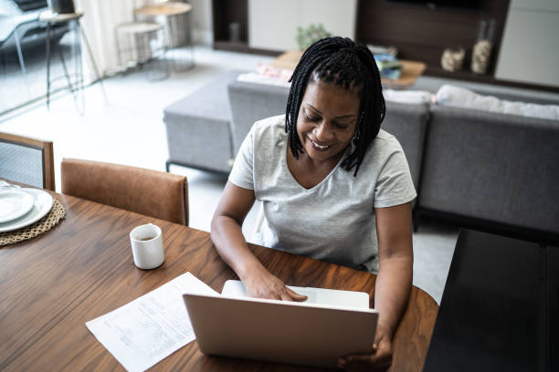 istock Mature woman using laptop working from home 1304403653