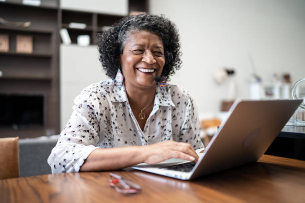Senior woman working as customer service representative at home