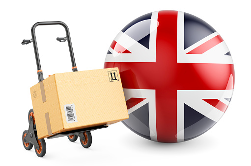 Parcel on the hand truck with British flag. Shipping in the Great Britain, concept. 3D rendering isolated on white background