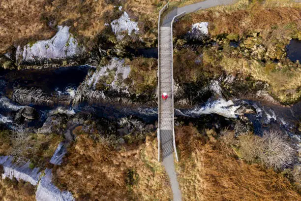 Photo of Aerial view of a senior man using on a footbridge