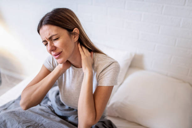 istock Young woman waking up with a neckache. 1304410574