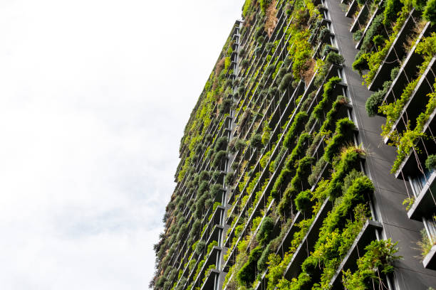 istock Low angle view of appartment building with vertical gardens, sky background with copy space 1304412523