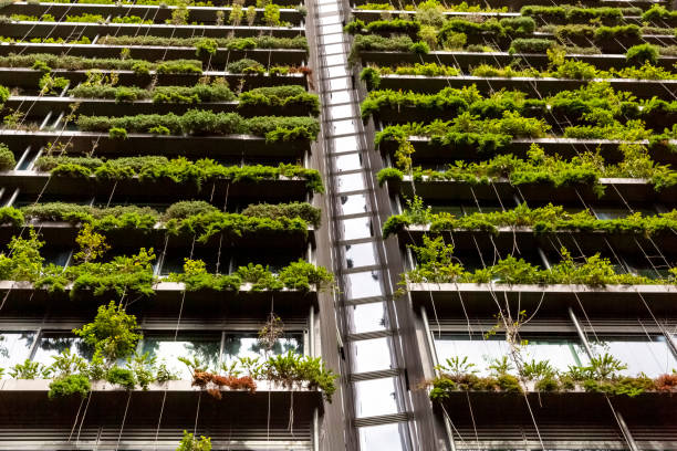 istock Low angle view of appartment building with vertical gardens, background with copy space 1304412873