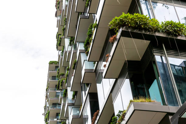 istock Closeup low angle view of appartment building with vertical gardens, background with copy space 1304413679