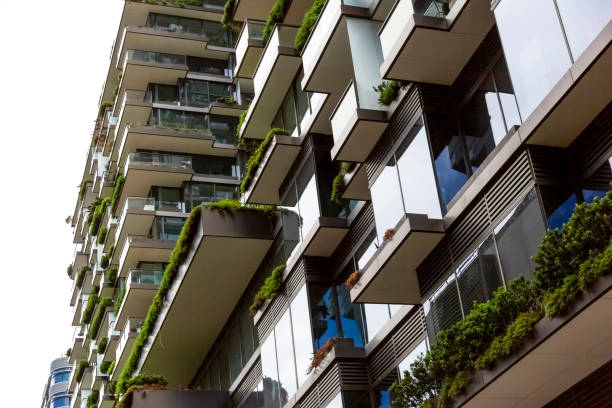 istock Closeup low angle view of appartment building with vertical gardens, background with copy space 1304413993
