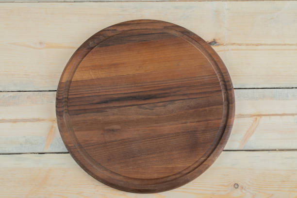 istock Rustic round wooden platter carved from oak tree 1304416515