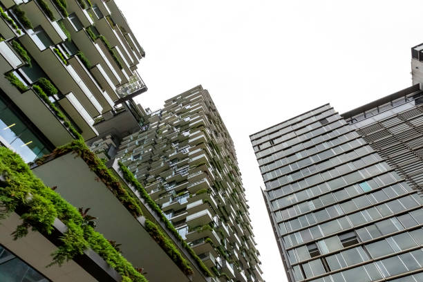 istock Low angle view of appartment buildings with vertical gardens, background with copy space 1304417633