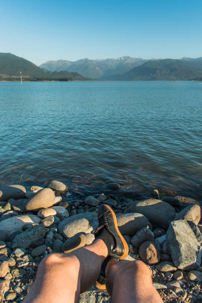 istock person facing lake and mountains 1304418262