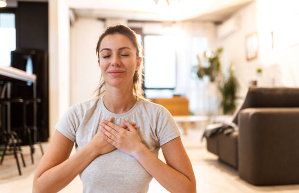 istock Young woman meditating at home. 1304420253