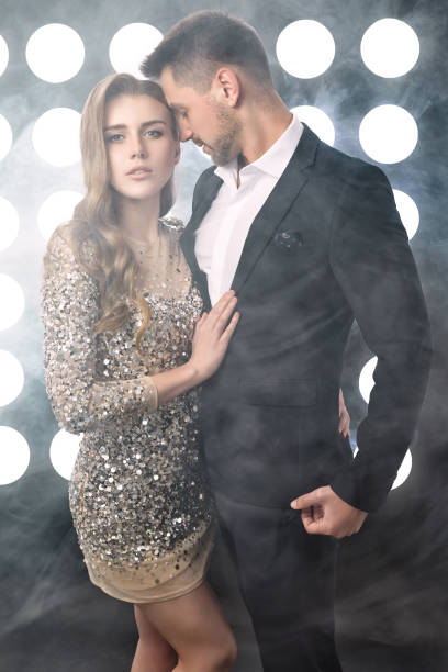 istock couple posing against the backdrop of spotlights 1304420334