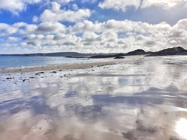 Magnificent landscape offered on the beach of Sable d'Or Les Pins - The sky is reflected on the water - Falling tide - Côtes d'armor - Brittany
