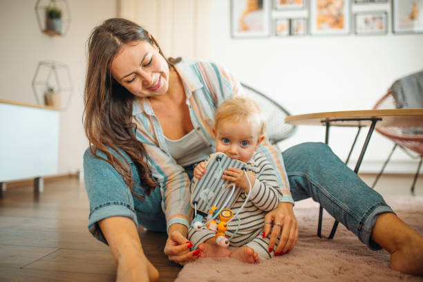 istock Young mom plays with her baby 1304424938