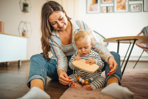 istock Young mom plays with her baby 1304424975