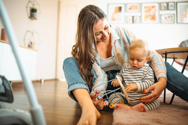 istock Young mom plays with her baby 1304425767
