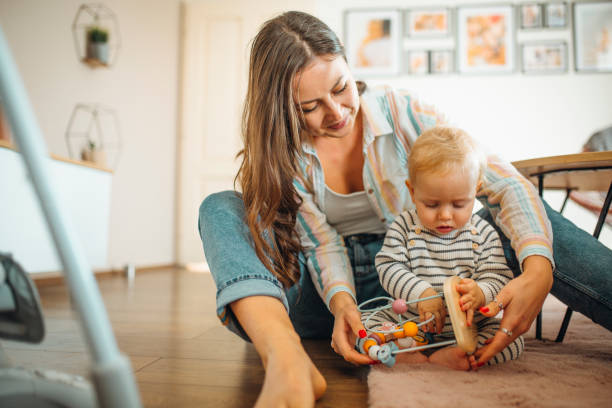istock Young mom plays with her baby 1304425772