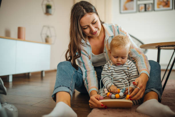istock Young mom plays with her baby 1304425860