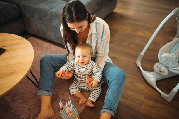 istock Young mom plays with her baby 1304425984