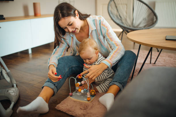 istock Young mom plays with her baby 1304426027