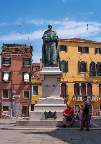Venice, Italy - 08 May 2018: Statue Of Paolo Sarpi. Paolo Sarpi is an Italian historian, theologian and Consul of Venice. At the foot of the monument sit tourists.