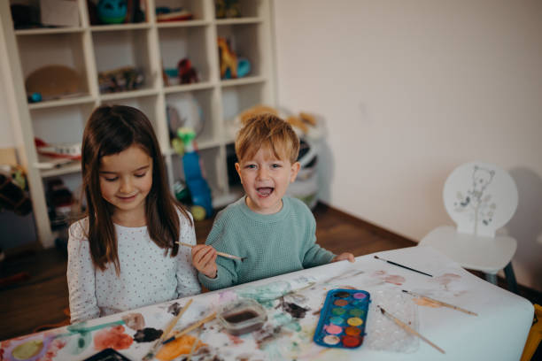 istock Brother and Sister painting 1304426298