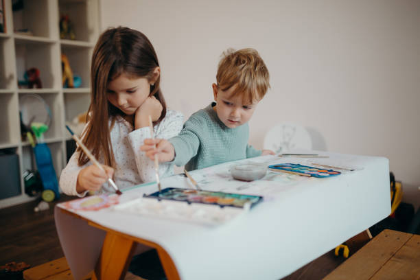 istock Brother and Sister painting 1304426434