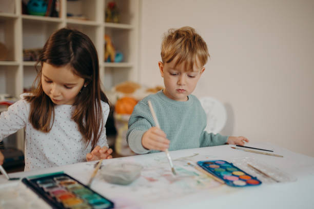 istock Brother and Sister painting 1304426981