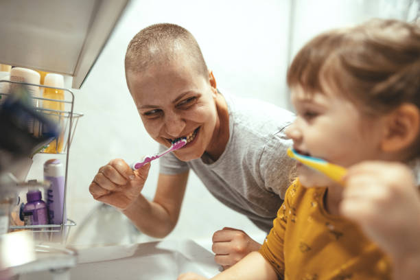 istock Cancer patient mother brushing teeth with her daughter 1304430148
