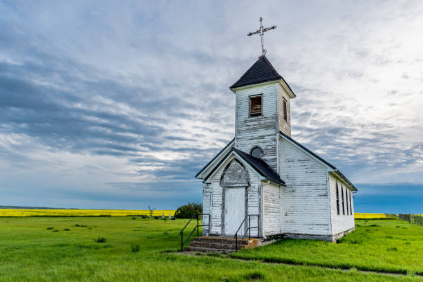 St. Marys Mission Church near Maxstone, SK St. Marys Mission Church near Maxstone, SK with a canola field in the background marys stock pictures, royalty-free photos & images