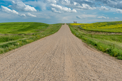 Gravel road in the country leading to the historic, yet abandoned Peace Lutheran Church in Stonehenge, SK