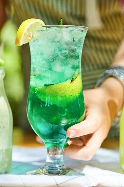 istock Hand holding a lemonade on wooden table 1304432765