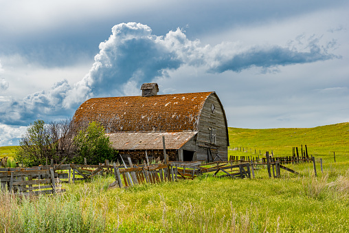 Dramatic, stormy sky over an old prairie barn in the Flintoft-Lankenheath area of Saskatchewan