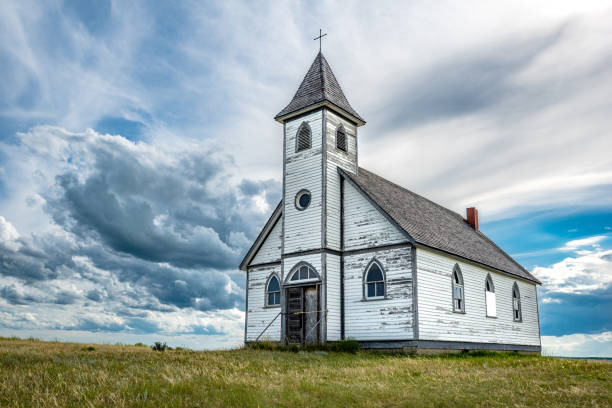 Dramatic sky over Peace Lutheran Church in Stonehenge, SK Dramatic sky over the historic, yet abandoned Peace Lutheran Church in Stonehenge, SK protestantism stock pictures, royalty-free photos & images