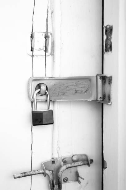 istock Padlock and Bolt on Rustic White Wood Door 1304438906