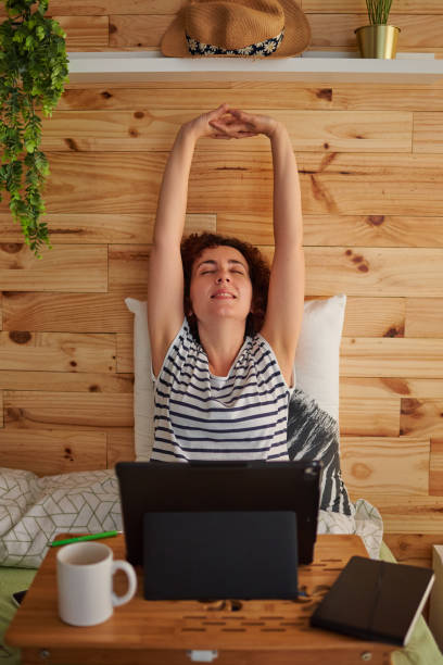 istock Woman stretches pleasantly during her telework day 1304445221